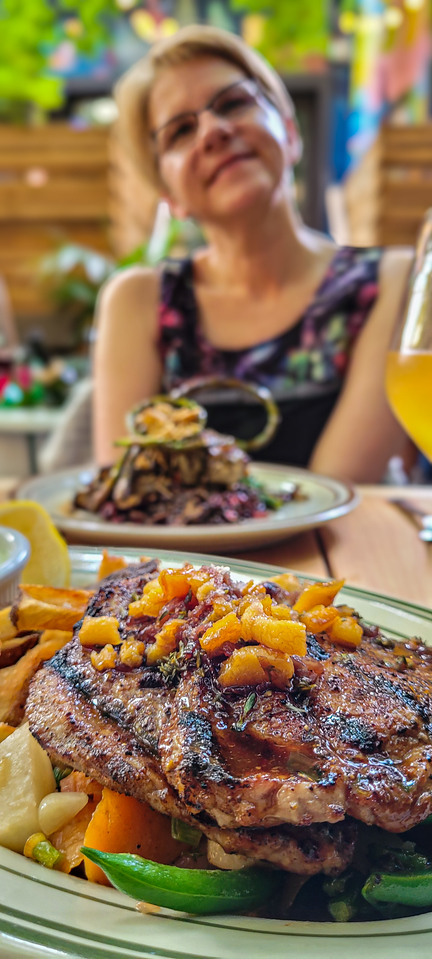 Pork entree, mushroom entree in background, patio.